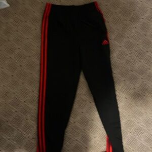 Adidas pants for boys size large black and red color-way.